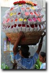 Flowers were being brought all over the market in various combinations, from basketfuls to headfuls, to hanging garlands