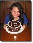 Alea shows off her cake (and lonely candle)