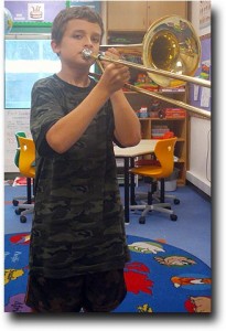 Breck playing his first notes on the trombone