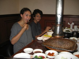 Alea and Breck seated at the cook-em-at-your-own-table Korean barbecue joint