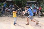 Breck swordfighting with local kids