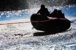 Breck and his cousins are silhouetted as they zoom across the lake.