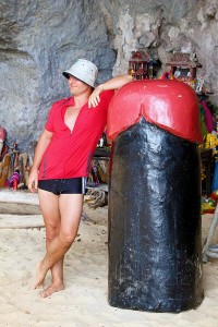 Category - Funny: A color-coordinated tourist poses with a giant phallic statue (lingam) in Phra Nang cave on Railay.