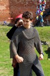 A "squire" helps put on the chain mail