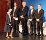 Alea goes on stage past the school board president, the dean of students, the head of school, and the high school principal.
